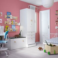 a child's bedroom with pink walls and white furniture