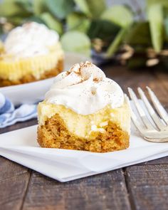 there is a piece of cake with whipped cream on it and a fork next to it