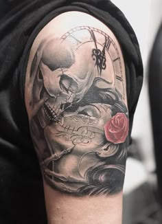 a man with a skull and rose tattoo on his arm