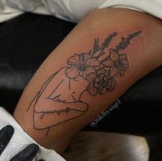 a woman's arm with flowers on it