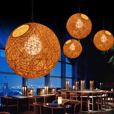 the lights are hanging over the tables in the restaurant's dining room, which overlooks the cityscape