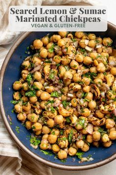 a blue bowl filled with cooked lemon and sumac marinated chickpeas