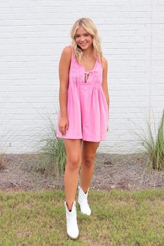 Feel flirty and fun with our pink denim romper! With its washed denim and playful pleated detail back, this romper is perfect for a country concert, a summer picnic, or a night out with friends. The deep v-neck with string tie adds a touch of playfulness, while the sleeveless design and side pocket provide comfort and convenience. Wear with our Chasing Summer tank (tight fitting underneath) for a more conservative feel. Made from high-quality denim, it's both stylish and durable, and sure to tur Pink Denim Romper, Pink Romper, Pink Denim, Pink Rompers, Country Concerts, Country Concert, Denim Romper, Activewear Sets, Summer Tank