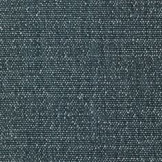 an upholstered dark blue fabric textured with small white dots on the surface