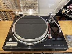 a turntable sitting on top of a wooden table