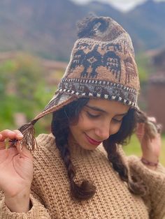 Andean alpaca wool beanie. This beautiful beanie is made by Hilaria from the Chahuaytire community, a part of the Quechua people living in the Sacred Valley of the Inka's in the Peruvian Andes.  ⛰️Chahuaytire community is known to be the best weavers among the Quechua people.  They maintain their ancestral knowledge of plants and weaving and bring it to the present.  🧵🦙They are involved in every part of making their products.  They have their own alpaca and lamas which they take care of, and o Traditional Beanie Hats For Winter, Traditional Beanie For Winter, Traditional Brown Winter Hat, Warm Multicolor Winter Bonnet, One Size Brown Alpaca Hat, Brown Alpaca Beanie Hat, Traditional Alpaca Beanie Hat, Knitted Alpaca Beanie Bonnet, Bohemian Hand-knitted Yarn Bonnet