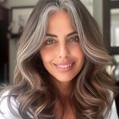 25 Best Hair Colors for Gray Hair, According to Experts Brunette Hair Going Grey, Ash Gray Hair Color For Morena, Blend Greys In Dark Hair, Brunette Gray Hair, Hair Color Ideas To Blend Grey Hair, Warm Gray Hair Color, Grey Hair Blending Brunette, Dark Hair Gray Blending, Gray Blending Brown Hair