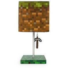 a lamp that is made to look like a minecraft table lamp with a green and brown shade