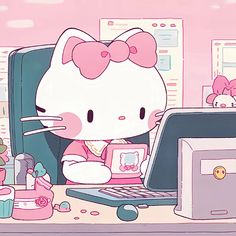 a hello kitty sitting in front of a laptop computer