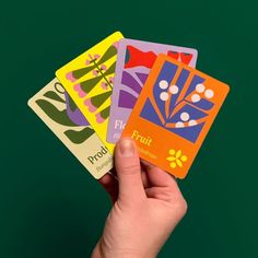 a person holding four cards in their hand