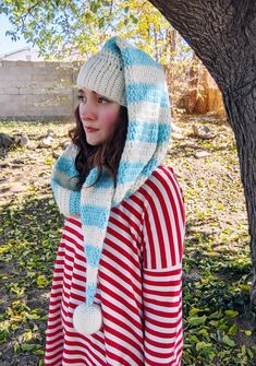 Make an adorable striped elf hat scarf with this crochet pattern! A hat-scarf. A Harf? A Scart? Well whatever you wanna call it, this cute elf hat wraps around your neck and functions as a scarf! It's super cozy and super cute! Read more on our blog! Pattern level: advanced (or ambitious) beginner. Must be comfortable sewing on small pieces, working in the round, changing colors. Sizes included: one size, fits nearly all teens & adults, measures about 62 inches long. Materials needed:- bulky (weight 5) yarn - I've used WeCrochet's Wonderfluff yarn- 4mm and 5mm hooks- yarn needle- stuffing for pom pom ball (you can just use leftover yarn!) What you will receive:A PDF written in English, using US crochet terms, with instructions on how to make this striped elf hat scarf. This is not a finish Christmas Scarf Crochet, Crochet Santa Hat Pattern, Crochet Elf Hat Pattern, Crochet Elf Hat, Crochet Kids Scarf, Santa Hat Pattern, Crochet Santa Hat, Wanna Call, Crochet Christmas Hats