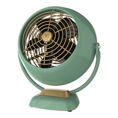 a green fan sitting on top of a table