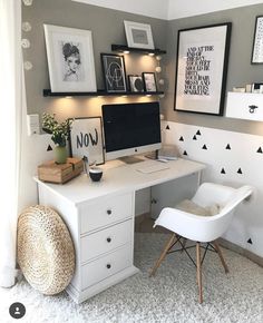 a home office with white furniture and pictures on the wall above it's desk