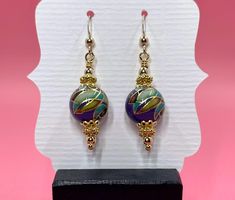 These Tensha purple mosaic earrings have a vintage feel to them. I accented the Tensha beads with gold vermeil spacer beads, gold vermeil bead caps and small round gold filled beads. They measure approximately 1 3/4 inches from the top of the gold filled earwire. Please note that images are enlarged to show detail. Click here to see other earrings in my shop: https://www.etsy.com/shop/JewelryDesignsByRita?section_id=14765680 I have been designing and making jewelry since 2010. I use only the hig Gold Round Beaded Earrings With Spacer Beads, Gold Beaded Earrings With Spacer Beads, Gold Czech Glass Earrings With Round Beads, Gold Czech Glass Beaded Earrings, Gold Earrings With Czech Glass And Spacer Beads, Elegant Dangle Earrings With Spacer Beads, Elegant Purple Jewelry With Gold Beads, Artisan Purple Round Bead Earrings, Nickel-free Yellow Gold Round Bead Earrings