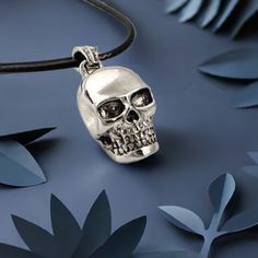 Experience the captivating allure of this Silver Skull Pendant, perfect for both men and women. As you search for the perfect gift for yourself or a loved one, look no further than this intricately designed pendant and accompanying necklace. And for those who prefer a different chain, go ahead and switch it out for the included waxed rope necklace. A must-have for any skull enthusiast or jewelry lover, and a unique and thoughtful gift for birthdays, Father's Day, or anniversaries. Embrace the daring and expressive spirit of the Silver Skull Pendant. DETAILS:Size: 3/4 inch x 1.2 inchCord: About 20 inches long (Black Waxed Rope)Color: SilverMaterial: Copper/Metal AlloyStyle: Punk • GET IT FAST!Get it fast! Ready to ship on 1 to 3 business days. • ORDER NOW!Limited Quantities / Limited Editio Skull Print Necklace For Halloween Gift, Symbolic Skull Shaped Jewelry For Gift, Halloween Skull Jewelry With Skull Print, Halloween Skull Jewelry With Engraving, Skull Shaped Stainless Steel Jewelry For Gifts, Skull Shaped Engraved Necklaces For Gifts, Gothic Jewelry With Skull Print For Gift, Halloween Stainless Steel Jewelry With Skull Print, Skull Shaped Engraved Necklace For Gift