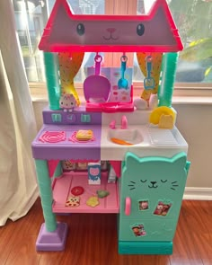 a toy kitchen with an oven, stove and sink