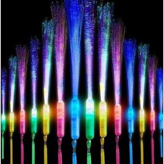 many different colored toothbrushes are lined up in a row on a black background