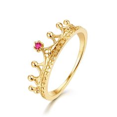 a gold ring with a pink stone in the middle and crown design on it's side