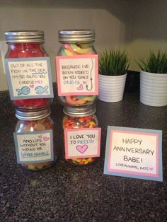 some jars filled with candy sitting on top of a counter