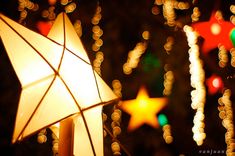 an umbrella is lit up in front of christmas lights