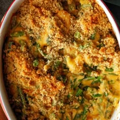 a casserole dish with broccoli, cheese and bread crumbs