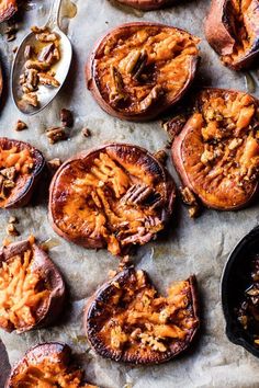 baked sweet potatoes with walnuts and pecans on a baking sheet, ready to be eaten