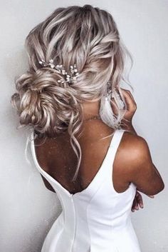 the back of a woman's head wearing a white dress