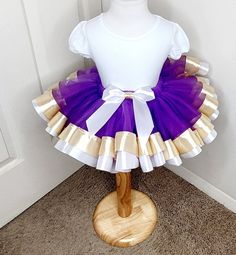 TUTU BIRTHDAY DRESS-Dress for Kids, Baby Girl Tutu Dress, Birthday Party Tutu, Purple And Gold Tutu, Gift for Little Girl This listing is just for the tutu only Tutu sizes are:  6-12 months--16 inch waist 6 inch length 12-18 months--17 inch waist 7 inch length 2T--18 inch waist 8 inch length 3T-4T--19 inch waist 9 inch length 5T-8--20 inch waist 11 inch length Machine Wash Cold & Hang Dry Please allow 10 business days for processing. Then allow another 5-7 days to arrive depending on shipping me Princess Style White Tutu Dress For First Birthday, White Ruffles Tutu Dress For First Birthday, White Ruffled Tutu Dress For First Birthday, White Princess Dress For Birthday, Gold Fitted Princess Dress For Birthday, Purple Princess Tutu Dress For Baptism, White Fitted Tutu Dress For Birthday, Gold Ruffled Dress For Birthday, Dress Birthday Party