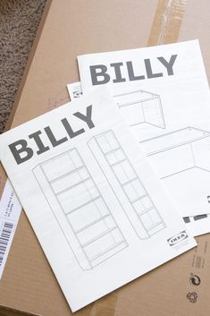 some papers are sitting on top of a cardboard box with the words billy written on it