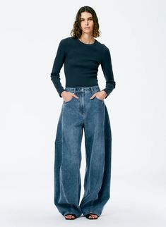 The Classic Wash Denim Sid Jean brings a unique aspect to your denim collection (and may be one of our favs) with its unique fit and design. This jean features both a wide leg silhouette that has a balloon-like shape as it gets tighter when it hits the floor. This pant is a mid-rise with a full bottom. It sits just below the waist and above the high hip. 100% Cotton Handkerchief Top, Satin Corset Top, Godet Skirt, All Jeans, Bleached Denim, Unique Fits, Denim Trends, Denim Collection, 가을 패션