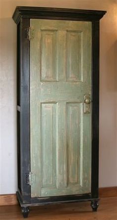 an old fashioned green door in a room