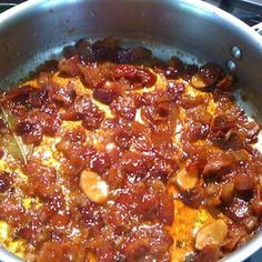 a pan filled with food sitting on top of a stove next to a burner