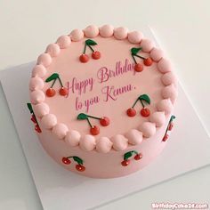 a pink birthday cake with cherries and the words happy birthday to you