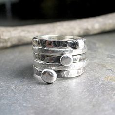 Set of FIVE stacking rings. Rustic stacking pebble rings accented by two textured fine silver bands. The 3 stackable sterling silver pebbles have been given an oxidized finish that is a great contrast to the two satin textured bright white fine silver accent rings. Meant to be slightly organic in shape, this rustic stack is a great casual, everyday look. They are also fun to play with, changing the position of the pebbles according to mood. when stacked on top of each other, they remind me of th Accent Rings, Pebble Ring, Silver Bands, Bee Ring, Hammered Sterling Silver, Nature Jewelry, Silver Accents, Wide Bands, Casual Everyday