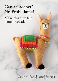 a llama ornament on a marble surface with the text can't croche? no prob - llama make this cute felt llama instead