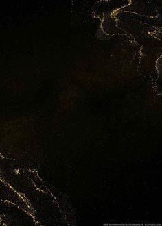 an abstract photograph of gold paint on a black background