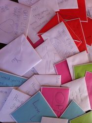 many different colored envelopes with writing on them