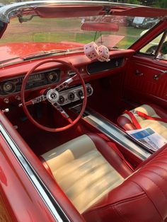 the interior of an old red car is clean and ready to be used for driving