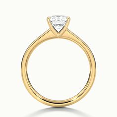 a yellow gold engagement ring with a single diamond in the center, on a white background