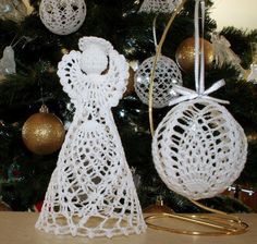 a crocheted angel ornament next to a christmas tree