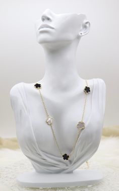 The Mother of Pearl and Black Five Leaf Flower Petal Pendant Necklace displays a radiant pendant crafted with five mother of pearl and black inlaid petals, forming an elegant flower design. This necklace, set on a simple chain, offers a touch of refined beauty that perfectly complements both everyday and formal attire. Length: 36 inches Clover: 14.9 mm Closure: Lobster Claw Material: Brass with 18K Gold Plating and Rhodium Coating Lead Free and Hypoallergenic Elegant Flower Shaped Mother Of Pearl Jewelry, White Flower-shaped Necklace With Pearl Pendant, Gold Flower-shaped Mother Of Pearl Jewelry, Elegant Flower-shaped Mother Of Pearl Necklace, Luxury Flower-shaped Mother Of Pearl Jewelry, Necklace Displays, Simple Chain, Leaf Flower, Flower Petal