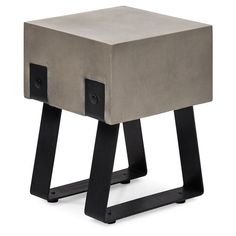 a cement and black metal side table with two square sections on one leg, the other end