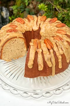 a bundt cake with pecans and caramel drizzle on top