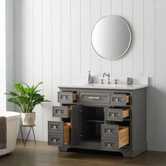 a bathroom vanity with drawers and a mirror