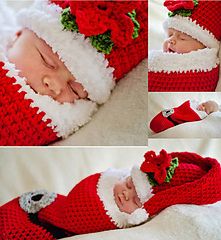 the baby is wearing a santa hat and sleeping