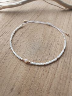 Delicate minimalist string cord bracelet made with creamy and gold toho round beads size 11. Simple, filigree and elegant design at the same time. It can be worn with casual or fancy outfit even for wedding dress The bracelet is adjustable thanks to a macrame slide knot. It is about 15 cm when fully tightened and about 28 cm when expanded. This bracelet is perfect for minimalist jewelry lovers or combine with other bracelets to create a stack!  If you need different size, feel free to ask Thank for visiting my shop! Please contact me if you have any questions!  ~~ Care instructions: To ensure that your piece of jewellery lasts a particularly long time, please avoid excessive contact with water, creams and perfumes and take it off overnight. Dainty White Resizable Jewelry, White Delicate Beaded Bracelet, Elegant Gold Beads Friendship Bracelets As Gift, Elegant Gold Beaded Friendship Bracelets As Gift, Delicate White Beaded Bracelet, White Delicate Adjustable Friendship Bracelets, Delicate White Round Beaded Bracelets, Delicate White Adjustable Friendship Bracelets, Delicate Adjustable White Friendship Bracelets