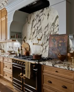 a kitchen with marble counter tops and an oven in the center, surrounded by wooden cabinets