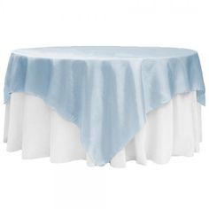 a blue and white table cloth on top of a round table