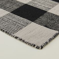 a black and white checkered rug on top of a table