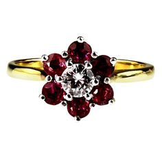 Red ruby flower cluster genuine retro ring, hallmarked London 1976. Let the fashionista in you bloom this summer and step out in style and in fantastic colour! These exquisite quality rubies blaze red in contrast to the cool white brilliant diamond, held in 18ct yellow and white gold for contrast and definition. This is one of a kind and when it's gone, it's gone. 1 x Round brilliant cut diamond, approximate total weight 0.40 carats, assessed color H/I, assessed clarity VS/SI 6 x Round cut rubie Vintage Cluster Ring, Engagement Rings Sale, Earrings Charms, Platinum Diamond Engagement Rings, Platinum Diamond Rings, Retro Ring, Blue Sapphire Diamond, Platinum Engagement Rings, White Gold Engagement